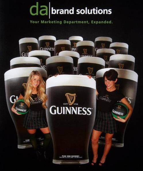 Guinness girls posing with pints of Guinness