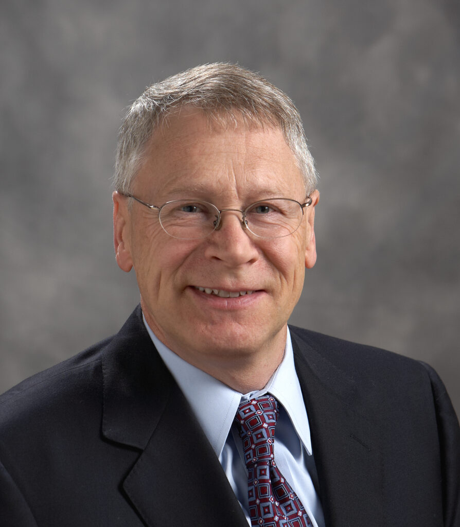 Smiling man in suit and glasses