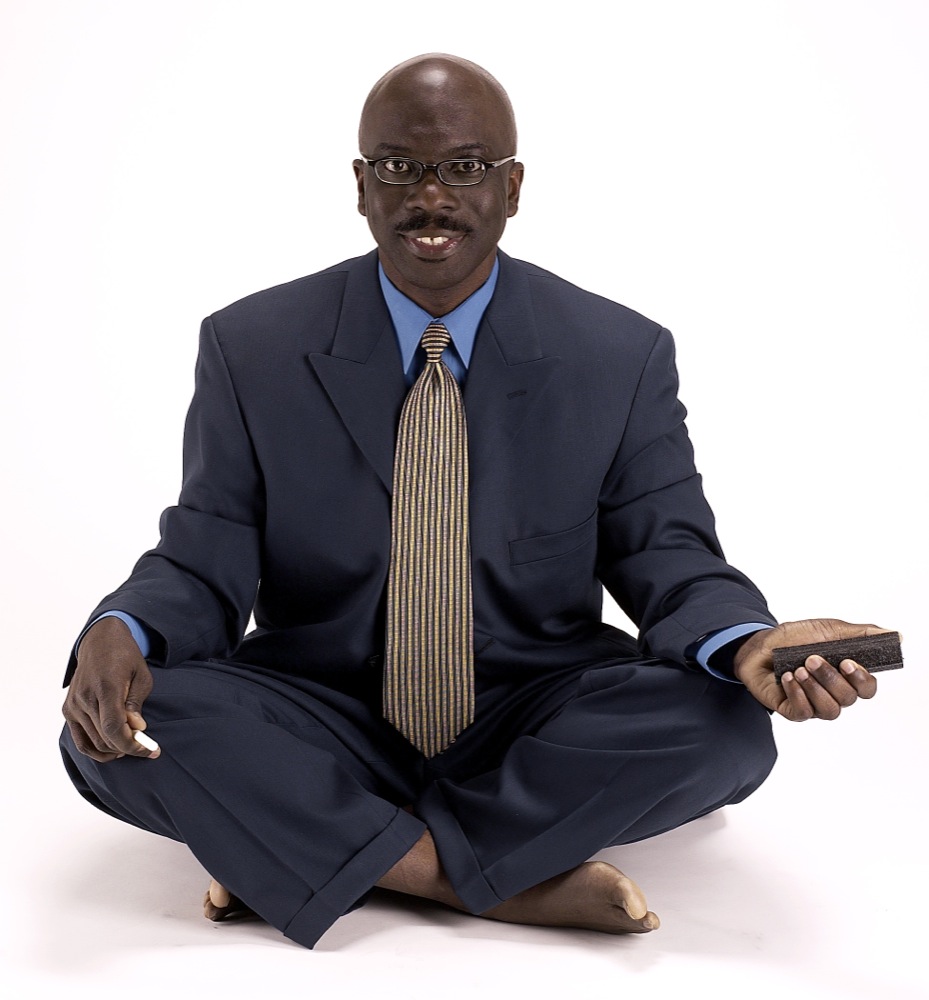 Smiling man sitting cross-legged
